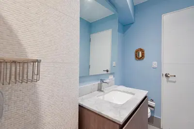 a bathroom with a sink and a mirror at ✶ Maras Residence ✶ LUXURY Rooftop Pool & Grill in Lima