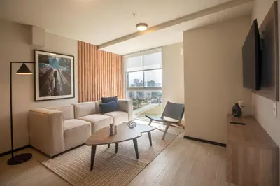 a living room with a couch and a table at Pionero by Wynwood House in Lima