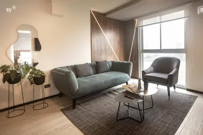 a living room with a couch and a chair at Pionero by Wynwood House in Lima