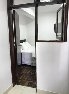 a room with a mirror and a bed in it at Minidepartamento céntrico entre Lince y San Isidro in Lima