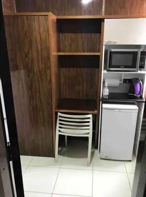 a small kitchen with a table and a microwave at Minidepartamento céntrico entre Lince y San Isidro in Lima
