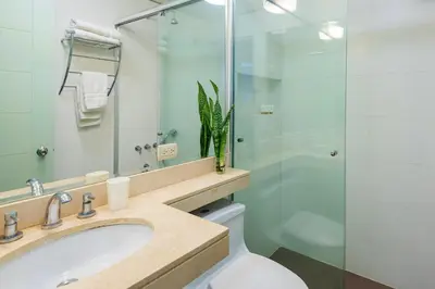 a bathroom with a sink and a glass shower at ✶ Kotosh Residence ✶ LUXURY Best Location & Piano in Lima