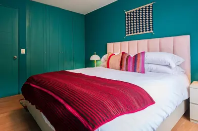 a bedroom with a large bed with green walls at ✶ Kotosh Residence ✶ LUXURY Best Location & Piano in Lima