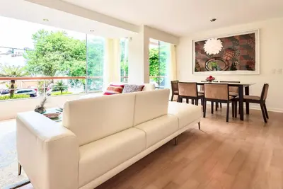a living room with a white couch and a table at ✶ Kotosh Residence ✶ LUXURY Best Location & Piano in Lima