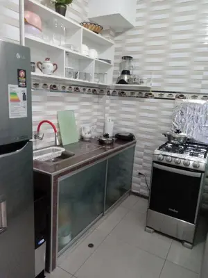 a kitchen with a counter and a stove in it at Departamento con servicios incluidos, equipado in Lima