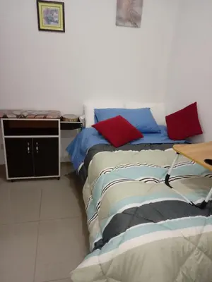 two beds sitting next to each other in a room at Departamento con servicios incluidos, equipado in Lima