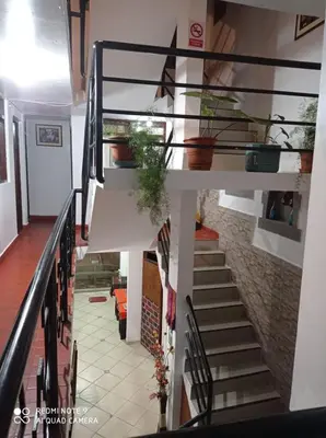 a stairway in a house with a stair railing at DENNY'S MAPI in Machu Picchu