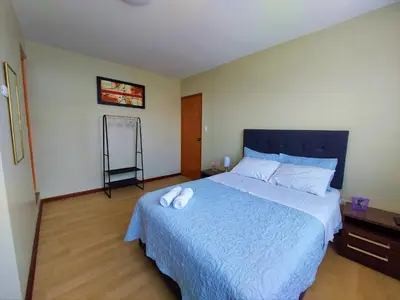a bedroom with a bed with two white towels on it at Casa Mahulu in Paracas