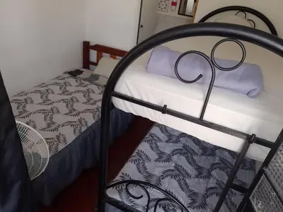 a bunk bed with a purple towel on top of it at Hotel Duna Sur in Laguna Huacachina