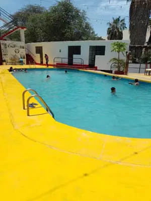 a large swimming pool with people in the water at Hotel Duna Sur in Laguna Huacachina
