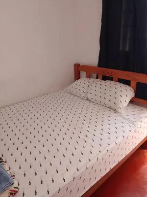 a bed with black and white sheets on it at Hotel Duna Sur in Laguna Huacachina