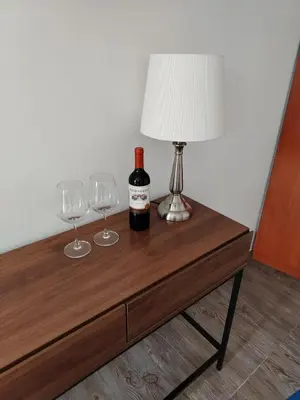 a table with a bottle of wine and two wine glasses at Casa Yuraq Hotel Boutique in Chincha Alta