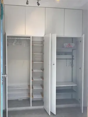 a white closet with white cabinets and shelves at Loft grande cerca al Olivar en San isidro-Lima in Lima
