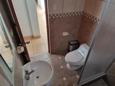 a bathroom with a toilet and a sink at Apart Hotel Doña Esther in Lima