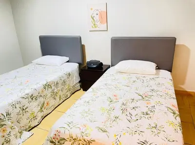 two beds sitting next to each other in a room at Apart Hotel Doña Esther in Lima