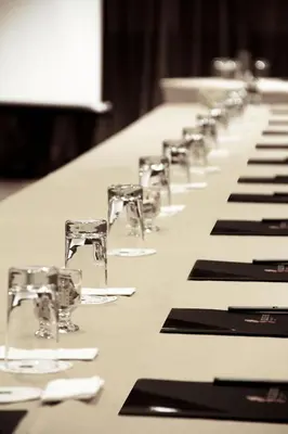 a long table with glasses and napkins at Sol de Oro Hotel & Suites in Lima