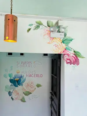a door with a camera on a wall with flowers at Tiyana House in Cusco