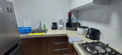 a small kitchen with a stove and a sink at Dpt suite pardo 610 in Lima