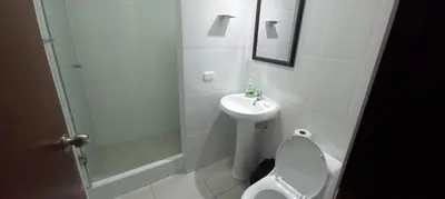 a white bathroom with a toilet and a sink at Dpt suite pardo 610 in Lima