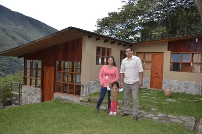 a man and a woman standing in front of a house at Lia B&B Lucmabamba in Sahuayacu