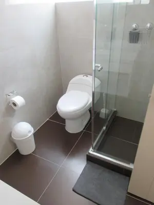 a bathroom with a toilet and a glass shower at Venue Studios in Lima