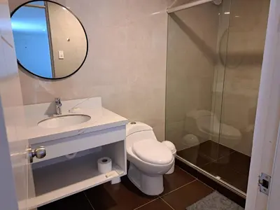a bathroom with a toilet and a sink and a mirror at Venue Studios in Lima