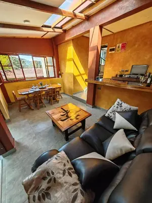 a living room with a couch and a table at Casa al lado del Bosque in Oxapampa
