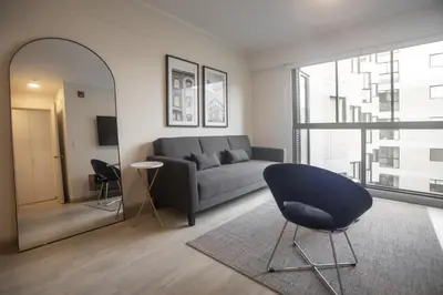 a living room with a couch and a chair at El Sol by Wynwood House in Lima