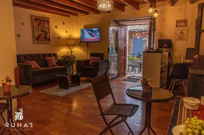 a living room with two tables and a couch at Rumi's Inn in Cusco