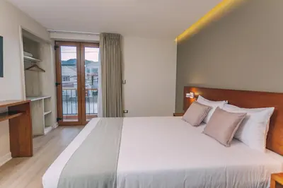 a bedroom with a large bed and a balcony at Saska Boutique Hotel in Cusco