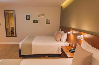 a hotel room with a bed and a mirror at Saska Boutique Hotel in Cusco