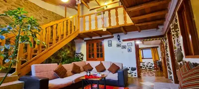 a living room with a couch and a staircase at Casa de Ollanta ByB in Ollantaytambo