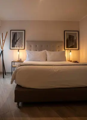 a bedroom with a large bed with two lamps at Espacio Luxury Apartments - Edificio Pedro de Osma in Lima