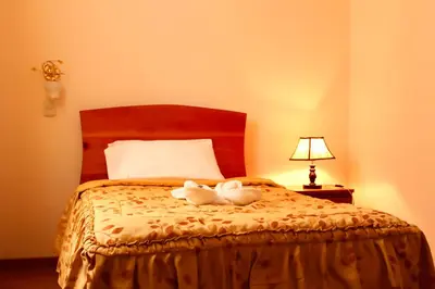 two stuffed animals sitting on top of a bed at Hotel Conquistador in Andahuaylas