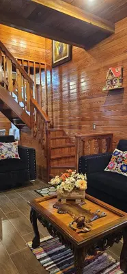 a living room with a couch and a coffee table at La Cabaña de Mari in Oxapampa
