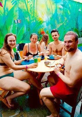 a group of naked people sitting at a table at Rainbow Hostel in Lima
