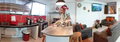 a kitchen with red cabinets and a counter top at Runa Apartamentos in Cusco