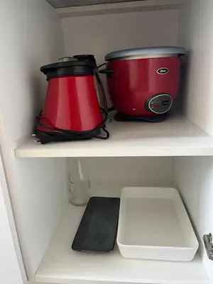 two pots and pans sitting on a shelf in a kitchen at Hermoso departamento totalmente amoblado - Lte San Miguel in Lima
