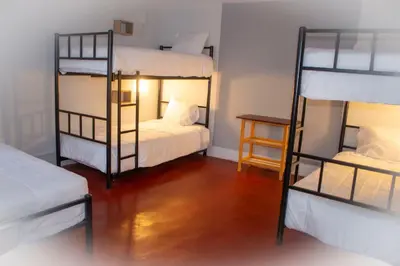 a room with two bunk beds and a table at Casa Kutimuy in Ayacucho