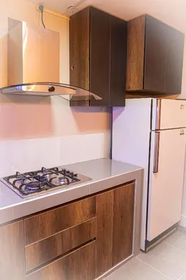 a kitchen with a stove and a refrigerator at Casa Kutimuy in Ayacucho