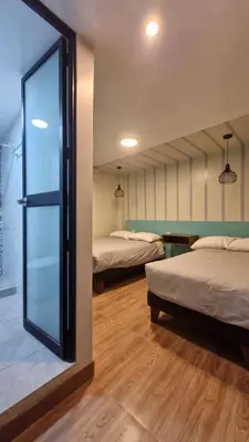 a room with two beds and a sliding glass door at Casa Kutimuy in Ayacucho
