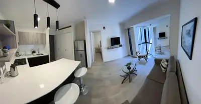 a kitchen and living room with a white counter top at BARRANCO Apartment Lima Peru in Lima