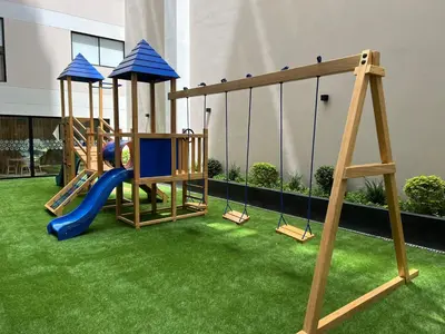 a playground with a slide and a swing set at BARRANCO Apartment Lima Peru in Lima