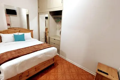 a bedroom with a bed with a blue pillow at Apartamento Entero en Centro de Miraflores - 2 habitaciones in Lima