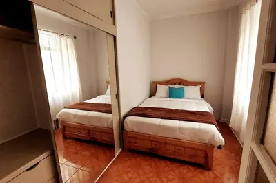 a small bedroom with two beds and a mirror at Apartamento Entero en Centro de Miraflores - 2 habitaciones in Lima