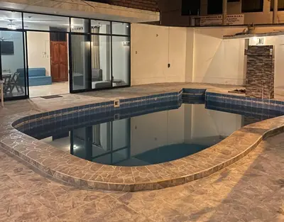 a large swimming pool in a building at Casa completa piscina 3 Habitaciones en Chanchamayo in La Merced