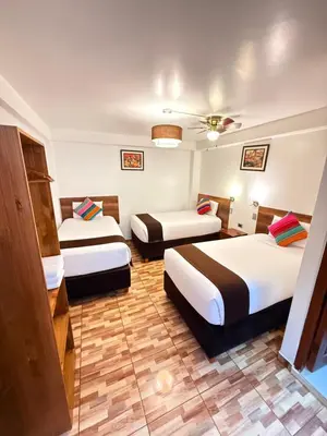 a hotel room with two beds and a ceiling at Inti Pacha Palace Machupicchu in Machu Picchu