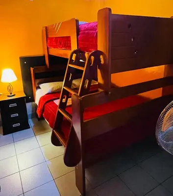 a bedroom with a bunk bed with a ladder at KORICANCHA in Lima