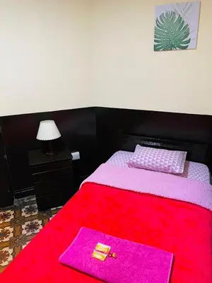 a bedroom with a red bed with a red blanket at KORICANCHA in Lima