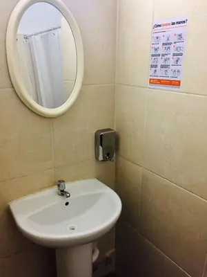 a bathroom with a white sink and a mirror at KORICANCHA in Lima